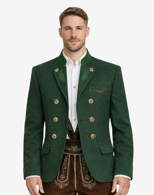 Model wearing alpine green wool men’s Trachten jacket featuring traditional Bavarian design, double-breasted metal buttons, green lapel accents, and classic Oktoberfest styling.