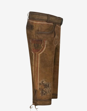 Side angle of alpine bundhosen highlighting leg embroidery, side pocket design and knee tie detail.