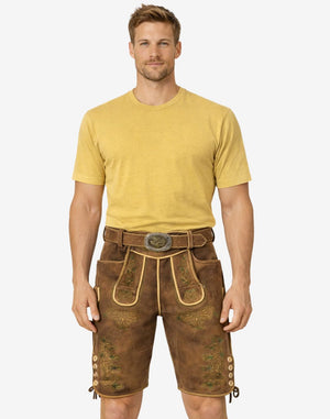 Front view of model wearing Alpine Vintage Men Lederhosen in brown leather with Bavarian embroidery and traditional belt buckle