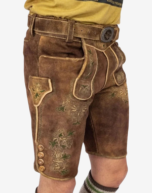 Alpine Vintage Men Lederhosen angled front view showing flap bib, side buttons, and green floral embroidery on thigh