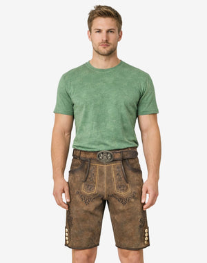 Model wearing authentic alpine lederhosen for men in brown leather with traditional Bavarian embroidery and belt buckle