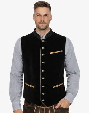 Man wearing a black vest with gold accents on a white background