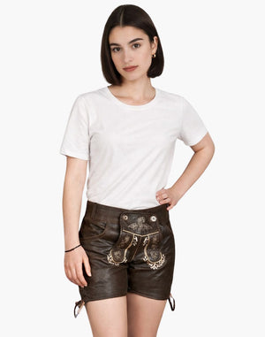Woman wearing a white t-shirt and brown leather shorts with decorative elements on a white background