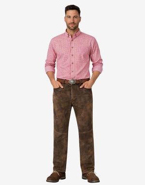 Man wearing a pink checkered shirt and brown pants on a white background
