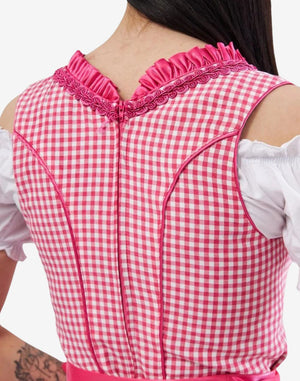 Close-up rear detail of bright pink dirndl dress showing gingham pattern, zipper closure and traditional Bavarian stitching