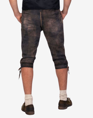 Back view of classic Bavarian bundhosen shorts worn by model highlighting leather texture, rear fit and traditional alpine styling