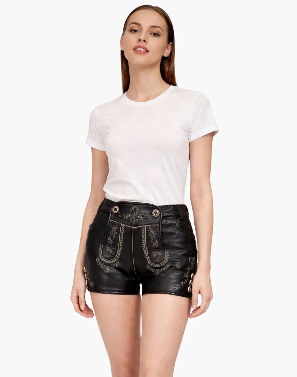 Woman wearing a white t-shirt and black leather shorts on a white background