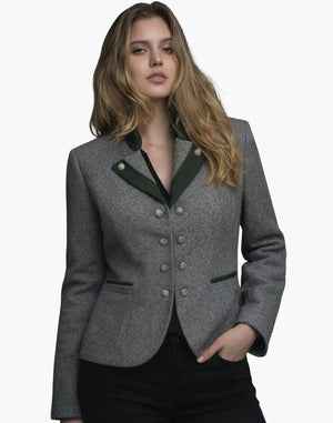 Front view of a woman wearing a tailored gray wool jacket with dark green lapel accents and decorative silver-tone buttons arranged in two vertical rows. The jacket features green-trimmed welt pockets and a fitted silhouette, paired with dark jeans. The background is plain light gray in a clean studio setting.