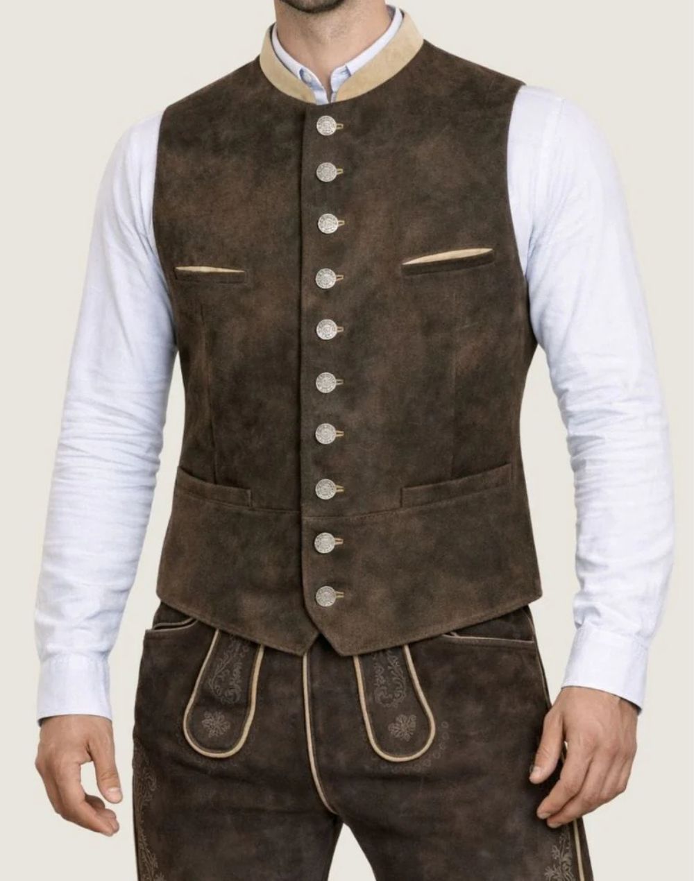 Close-up of dark brown suede Trachten vest for men featuring traditional metal buttons, contrast trim and premium suede texture.