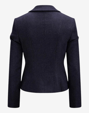Back view of a women’s navy blue tailored trachten-style jacket featuring a structured fit, clean seam detailing, long sleeves, and a classic Alpine-inspired design.