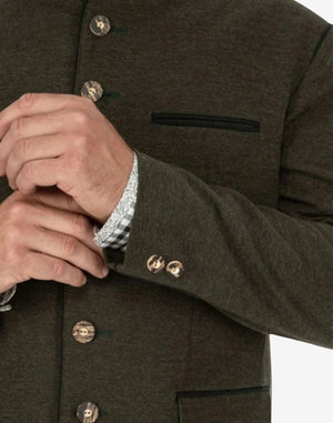 Close up of green wool Trachten jacket showing decorative side buttons and pocket trim with traditional Bavarian craftsmanship.