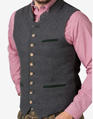 Angled close-up view of grey wool Alpine piping vest highlighting textured fabric, horn-style buttons, and green contrast trim detailing.