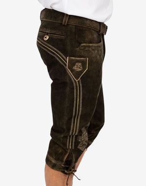 Side angle highlighting embroidered leg panel, decorative stitching and textured leather finish on handmade Bavarian bundhosen