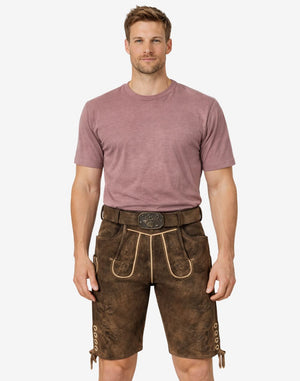 Front view of model wearing Men Alpine Champion Lederhosen in brown leather with Bavarian embroidery and traditional belt buckle