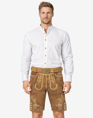 Model wearing Bavarian tan lederhosen for men in light brown leather with traditional embroidery and belt buckle