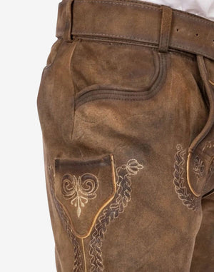 Close-up of embroidered side pocket on brown bundhosen highlighting stitching detail and textured leather surface