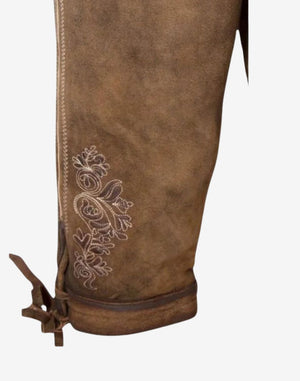 Side detail of mens Oktoberfest bundhosen highlighting embroidered leg pattern, stitching detail and authentic leather texture