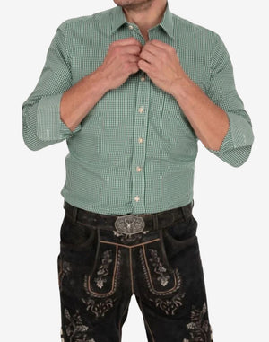 Model wearing green Bavarian Oktoberfest shirt paired with lederhosen showing fitted waist and traditional alpine look