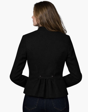Back view of a woman wearing a modern black tailored blazer with a fitted waist and pleated back detail, paired with dark jeans, against a white background.