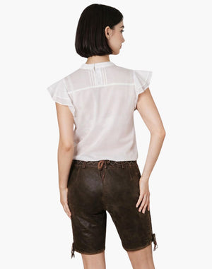 Woman wearing a white top and brown leather shorts on a white background