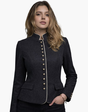 Woman wearing a premium Bavarian Trachten jacket in dark charcoal grey with contrast piping, decorative buttons, and a fitted traditional design, against a white background.