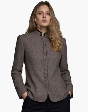 Woman wearing a brown blazer with button details on a white background