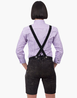 Person wearing a purple checkered shirt with black suspenders and dark shorts on a white background