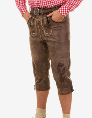 Side view of model wearing premium Oktoberfest bundhosen highlighting fitted cut, embossed leather details and traditional alpine styling.