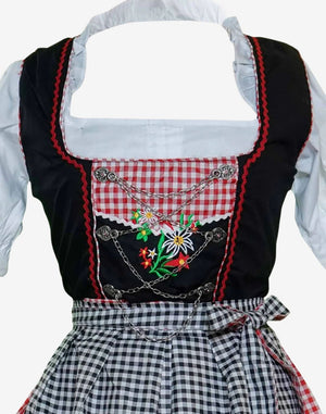 Close view of dirndl bodice highlighting floral embroidery, chain detail, check fabric panel and authentic Alpine design