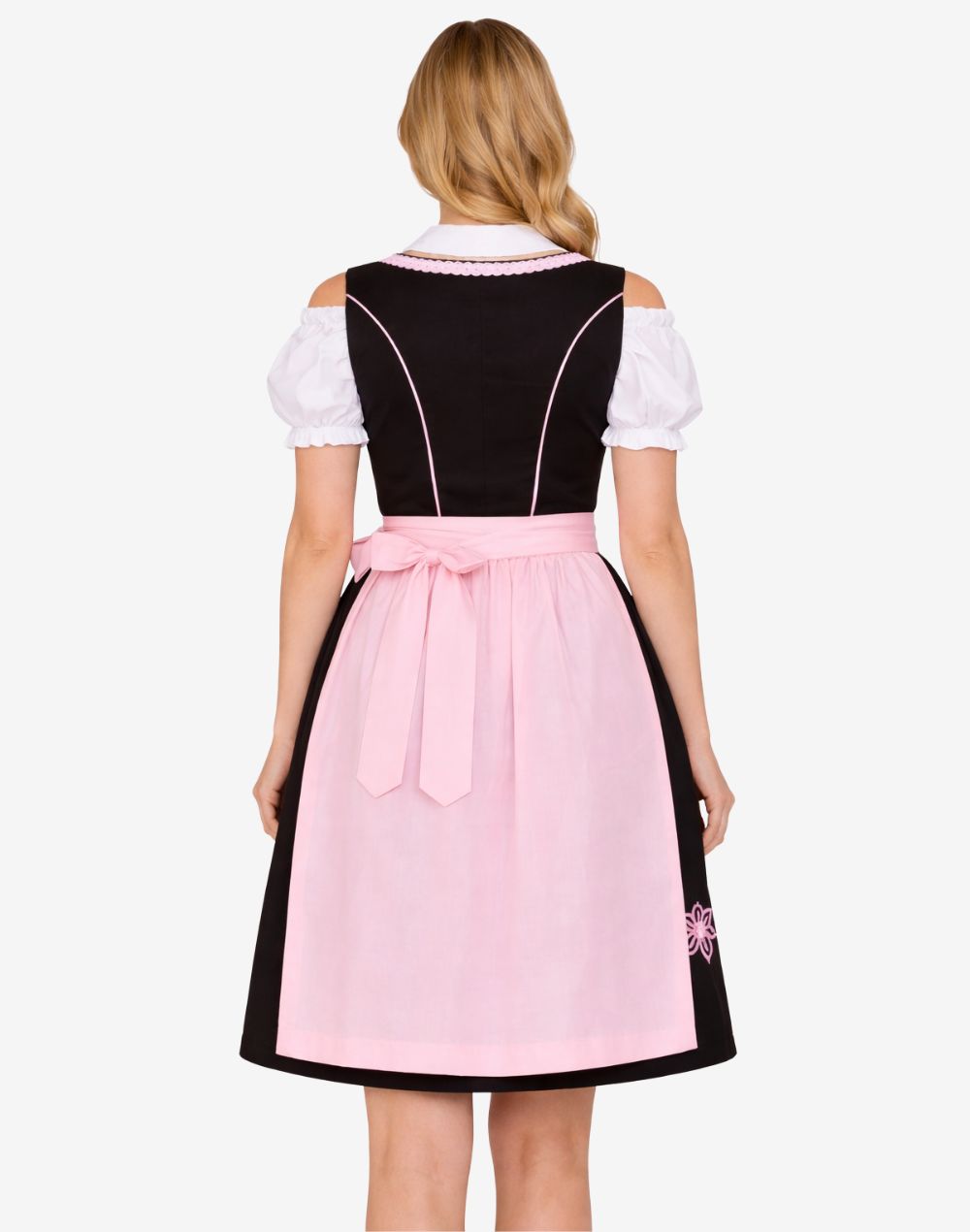 Back view of model wearing rustic German dirndl dress featuring structured bodice, pink apron bow and classic Bavarian silhouette