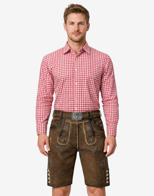 Model wearing rustic mens traditional lederhosen in brown leather with Bavarian embroidery and classic Oktoberfest belt buckle