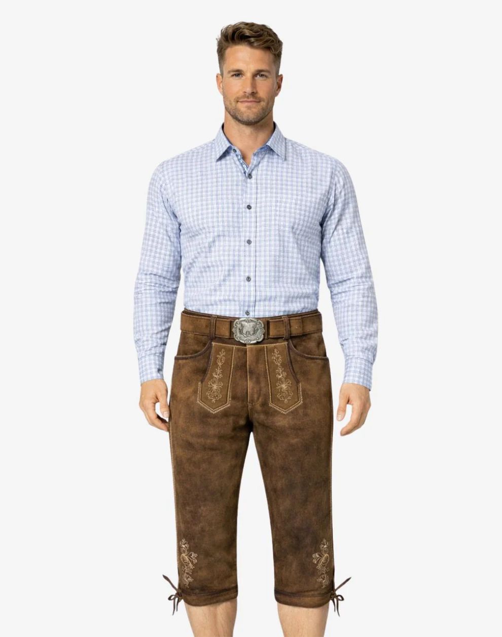 Man wearing a light blue checkered shirt and brown traditional pants on a white background