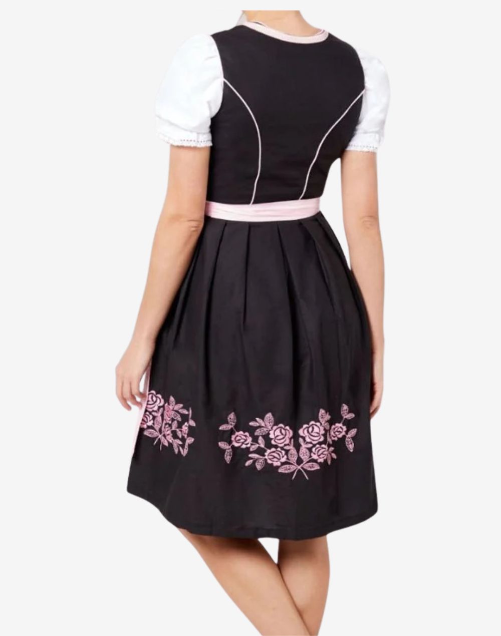 Back view of model wearing timeless Bavarian dirndl dress featuring pleated skirt, pink bow tie apron and floral embroidery