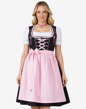 Full front view of model wearing timeless Bavarian dirndl dress with lace blouse, pink apron bow and traditional alpine fit