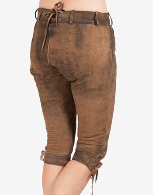 Back view of women’s brown leather bundhosen featuring an aged rustic finish, adjustable waist tie, knee-length cut, and lace-up detailing at the cuffs.