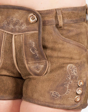 Close-up of brown suede women’s lederhosen showing traditional embroidered detailing on the front flap and leg, with decorative side buttons and a vintage-style finish.