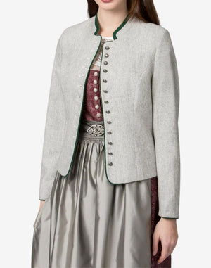 Women’s traditional light grey Bavarian trachten jacket with green piping and decorative front buttons, styled over a classic dirndl dress with patterned bodice and pleated skirt.