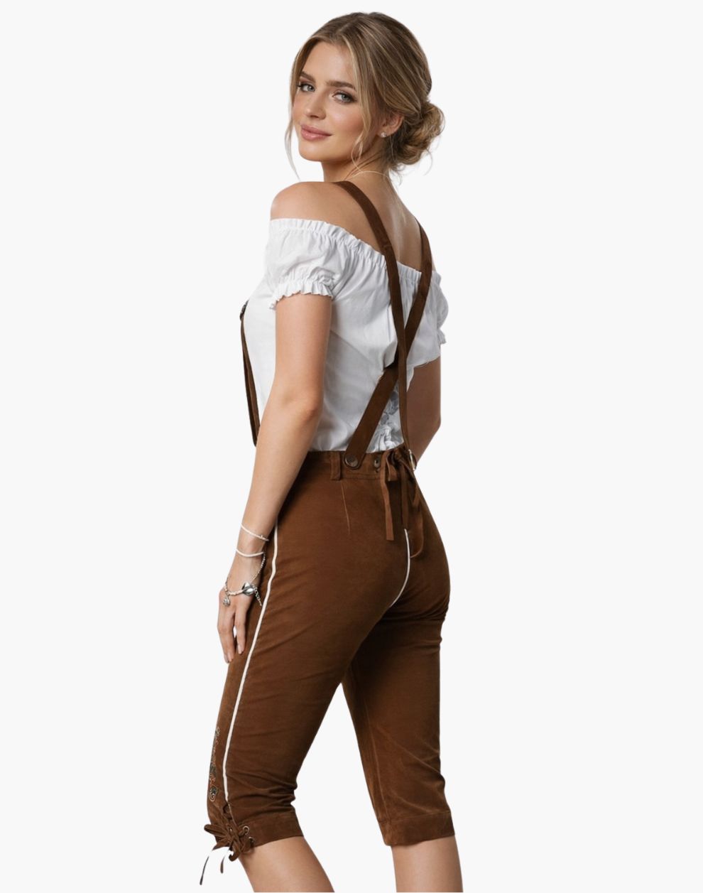 Woman wearing a white top and brown pants with suspenders on a white background