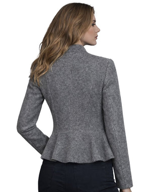 Woman wearing a gray peplum jacket on a white background