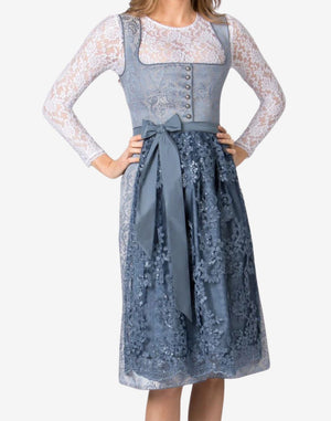 Model wearing womens Oktoberfest dirndl dress highlighting lace skirt texture, fitted bodice and elegant apron ribbon