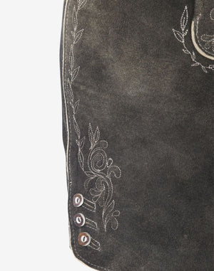 Close-up of grey leather women’s lederhosen showing traditional embroidered floral detailing along the leg and decorative side buttons on a vintage distressed leather finish.
