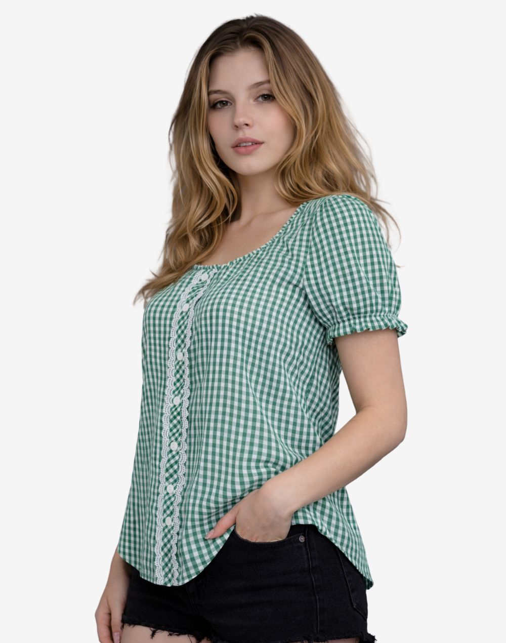 Front angled view of a woman wearing a green and white gingham check peasant blouse with short puff sleeves and decorative white lace panel, paired with black denim shorts.