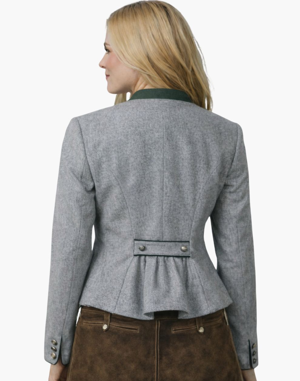 Back view of a woman wearing an authentic alpine Trachten jacket in light grey with a green collar, fitted waist, and pleated back detail, paired with brown lederhosen, against a white background.