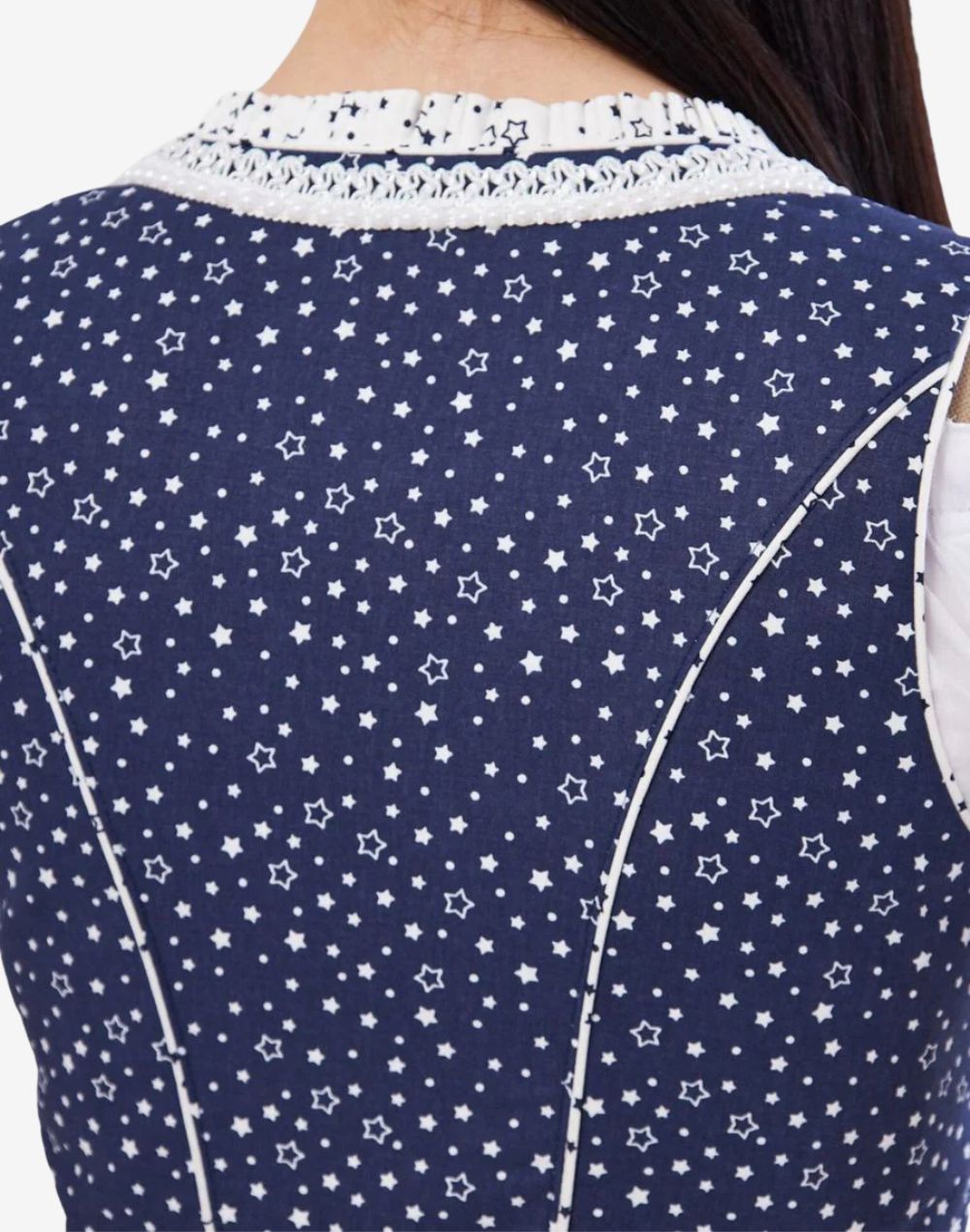Rear close view of womens elegant traditional dirndl dress showing navy star pattern fabric, fitted bodice seams and trim