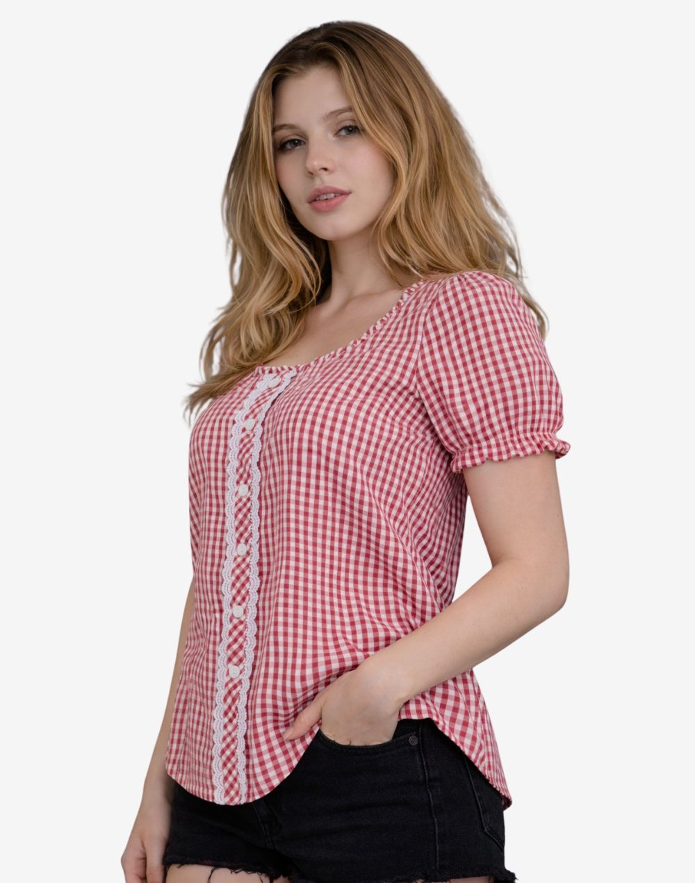 Angled front view of a woman wearing a red and white gingham Bavarian-style blouse with short puff sleeves, lace-trimmed button panel, and fitted silhouette, paired with black denim shorts.