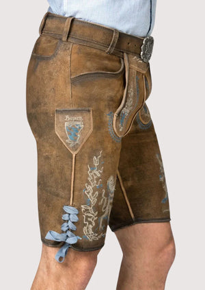 Side view of men’s brown leather lederhosen with traditional Bavarian embroidery and lace ties