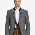 Model wearing alpine dark gray wool men’s Trachten jacket with traditional Bavarian design, double-breasted buttons, green collar accents, and classic Oktoberfest styling.