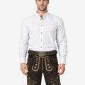 Model wearing Alpine flower lederhosen for men in brown leather with traditional Bavarian floral embroidery