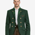 Model wearing alpine green wool men’s Trachten jacket featuring traditional Bavarian design, double-breasted metal buttons, green lapel accents, and classic Oktoberfest styling.