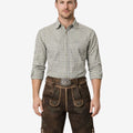 Model wearing alpine style lederhosen for men in dark brown leather with Bavarian embroidery and traditional belt buckle